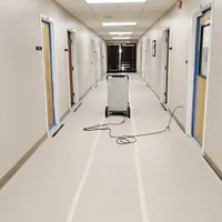 Commercial HEPA air scrubber running in a protected hallway