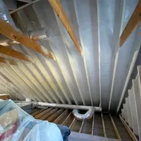 Attic with exposed rafters and ductwork during mold remediation