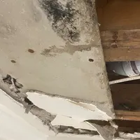 Water-damaged ceiling drywall with mold above a leak