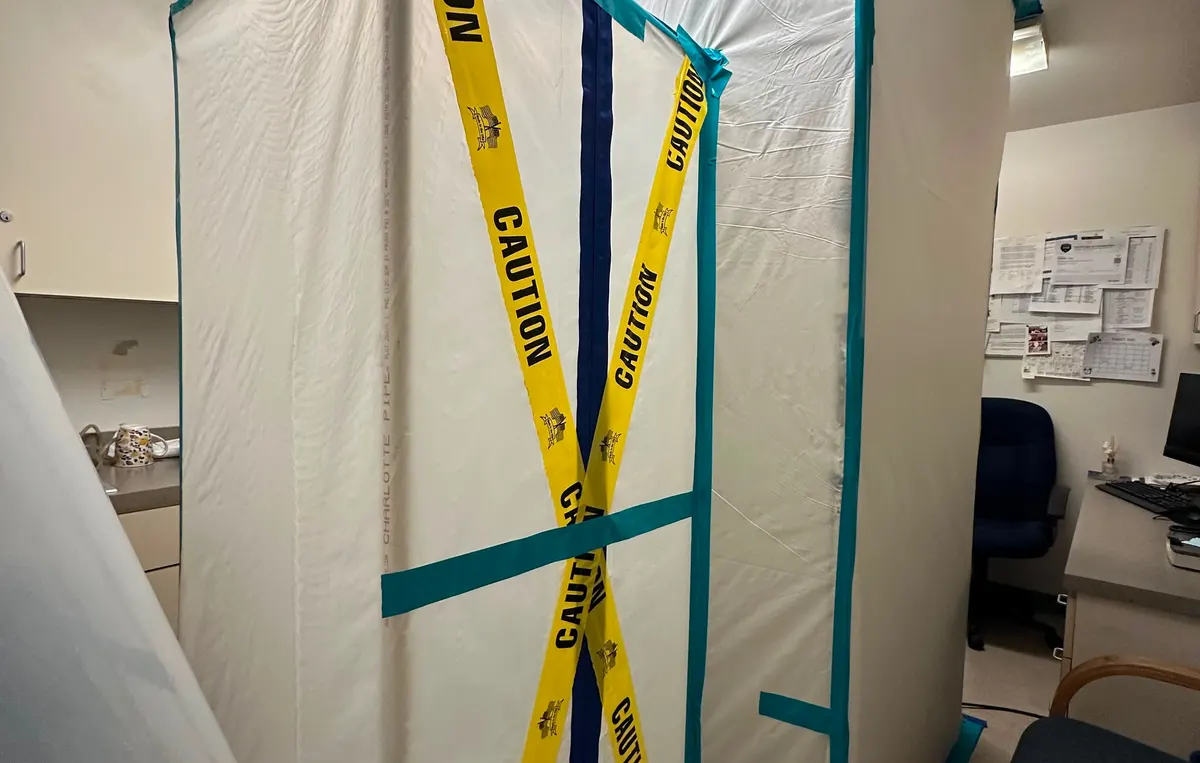 Mold containment with caution tape and air scrubber in a New Jersey property